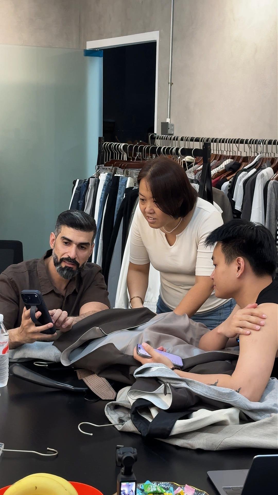 HUYU Apparel team discussing fabric and garment details with a customer
